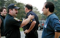 A police officer chats with race director Patrick Farris